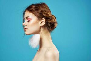 attractive woman naked shoulders fluffy earrings bright makeup photo
