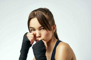 sportive woman with bandaged hands boxing exercise workout photo