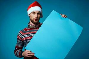 Cheerful man in a santa hat holding a banner holiday isolated background photo