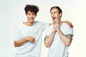 two guys in white t-shirts next to friendship communication emotions photo