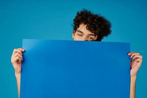 Cheerful guy with curly hair blue mockup Poster Studio photo