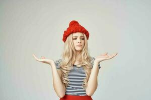 beautiful woman in fashionable clothes Red Hat light background Lifestyle photo