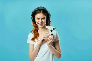 woman with headphones listening to music entertainment technology fashion blue background photo