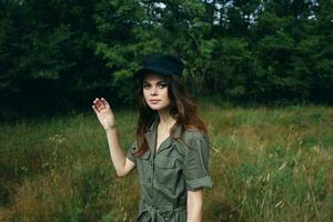 woman in the forest Woman in green jumpsuit black cap look ahead freedom fresh air photo