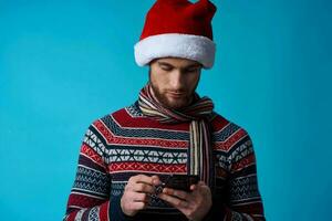 handsome man with a phone in hand holiday christmas technology studio posing photo