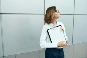 Business woman documents professional work office near building photo