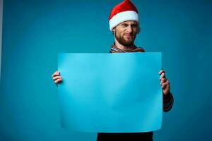 emotional man in a santa hat holding a banner holiday isolated background photo