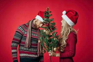 man and woman christmas holiday new year romance red background photo