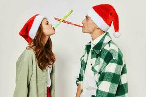 young couple christmas hats pipes holiday relationship fun photo