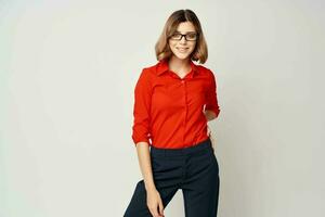 woman in red shirt posing fashion official light background photo