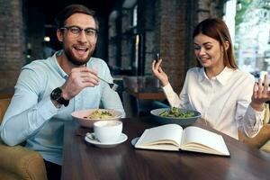 cheerful young couple in cafe breakfast work colleagues lifestyle photo