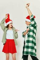 Cheerful young couple celebrating New Years with hands raised up photo