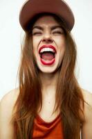 Beautiful woman in a cap Fun wide open Mouth closed eyes sexy look photo