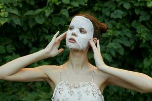 Portrait of a girl Looks to the side and hands near the face anti-aging mask skin care photo