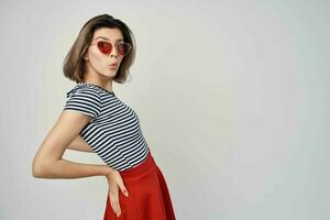 woman wearing sunglasses red skirt street fashion isolated background photo