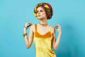 woman in multicolored turban luxury ethnicity blue background photo