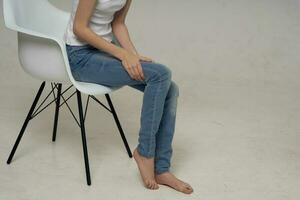 woman sitting on a chair leg injury health problems photo