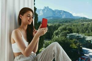 pretty woman with a red phone Terrace outdoor luxury landscape leisure Relaxation concept photo