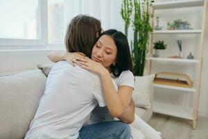 An Asian woman hugs her husband and smiles. The joy of using the family and the good psychological state after the quarrel photo