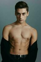 Portrait of a young man with a naked torso sporty appearance Copy Space photo
