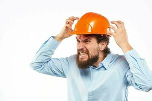 Angry man in orange hard hat industry work dissatisfaction cropped view photo