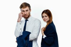 man and woman in suits are standing next to work colleagues finance office light background photo