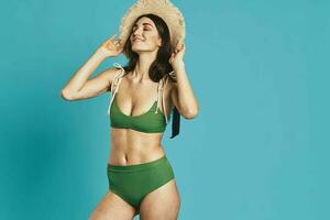 woman in green swimsuit beach season summer glamor photo