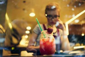 woman with glasses sitting in a restaurant cocktail vacation loneliness photo