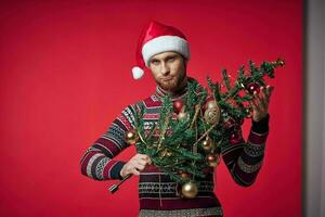 man with christmas tree toys holiday decoration red background photo