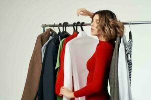 beautiful woman in a red jacket near the wardrobe isolated background photo