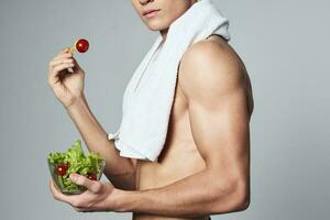 athletic man bodybuilder healthy eating plate salad close-up photo