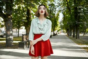 pretty woman in red skirt in the park walk lifestyle fresh air photo