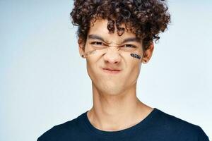 emotional man with curly hair cosmetics skin care close-up photo