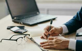 man in suit in front of laptop office manager finance photo