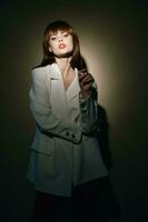 brunette in beige jacket gesticulate with hands isolated background photo