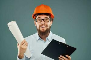 Cropped view of cheerful bearded man in orange paint in glasses with documents in hands photo