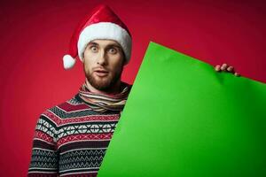 emotional man in a santa hat holding a banner holiday isolated background photo