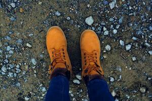 female feet in boots on the ground nature top view photo