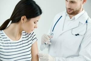 male doctor giving an injection to a woman vaccination health coronavirus photo