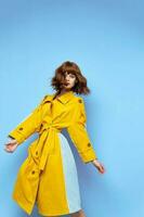 fashionable woman in yellow coat striped fabric brunette makeup photo