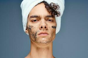 guy with a towel on his head cosmetics skin care close-up photo