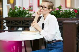 female in a summer cafe reading walk in the fresh air Lifestyle photo