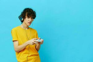 curly guy in headphones plays games gamepad Lifestyle entertainment photo