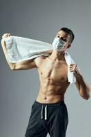 sports man muscular torso white towel medical health mask gym photo