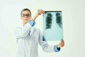 female doctor holding an x-ray in front of her hospital treatment diagnosis photo