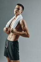 man in black shorts towel on shoulders gym exercise photo