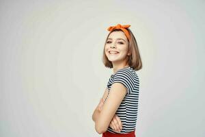 cheerful woman with orange bandage on her head posing emotions model photo