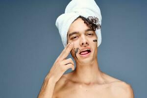 guy with a towel on his head face cream skin care photo