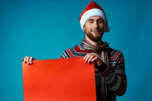 handsome man in a santa hat holding a banner holiday isolated background photo