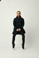 man in black coat bounced up and shoes pants jacket suit photo
